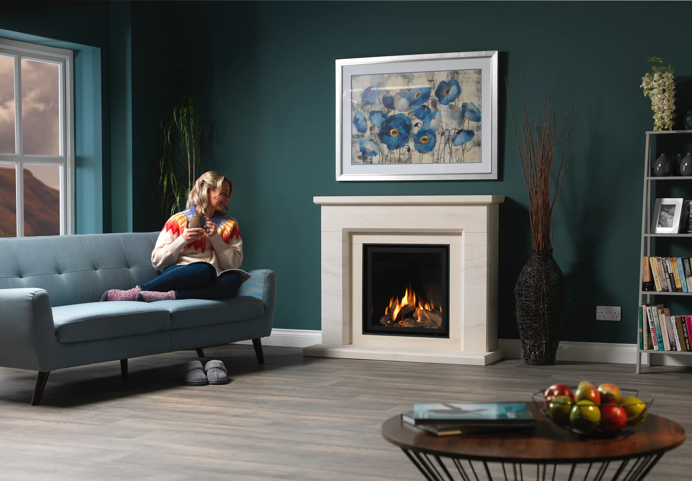 A Wildfire Ravel 600 gas fire with an Asti surround in a furnished living room