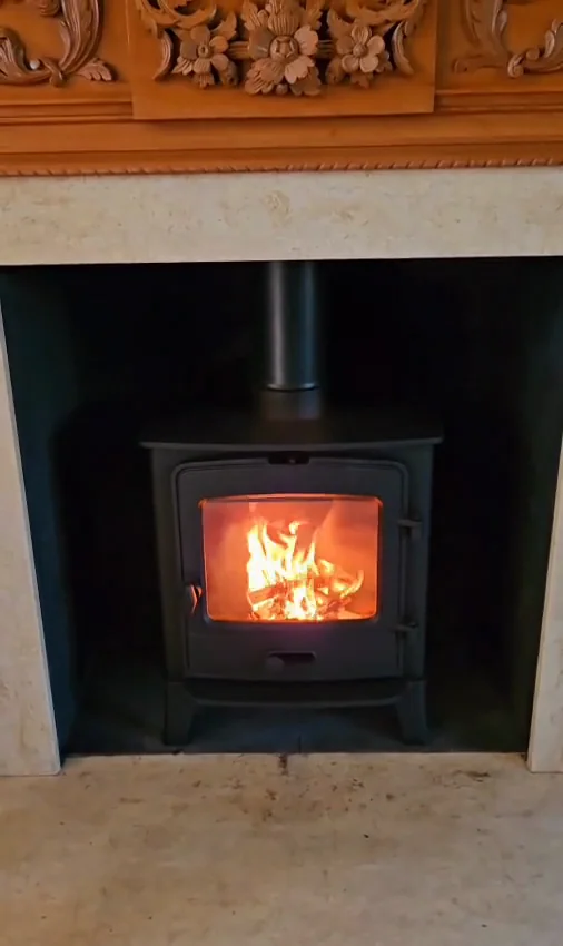 A stove beneath a carved mantel