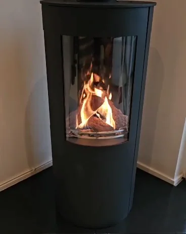 A tall, curved-glass stove